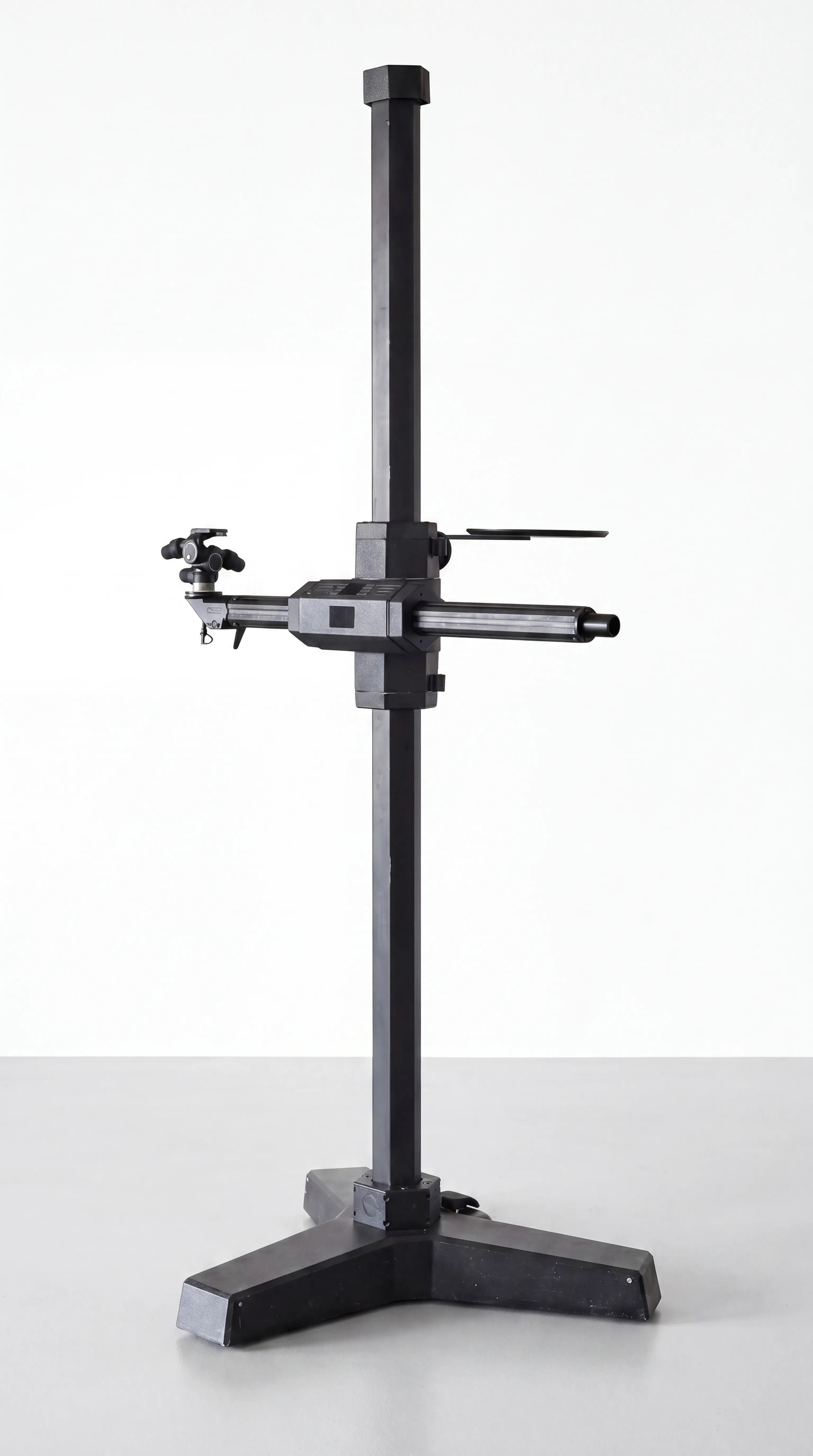 FOBA DSS ALPHA professional studio stand — black column stand with crosspiece beam and cast-iron base against a concrete wall